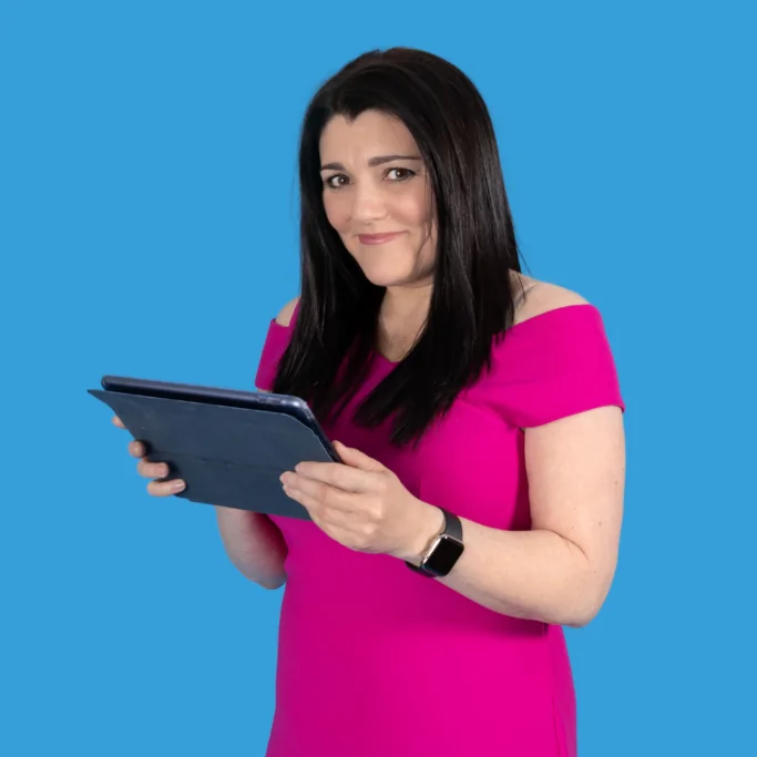 Tracy blue background with ipad Tracy Heatley with her ipad ready to show someone her networking training information. This image is for the home page.