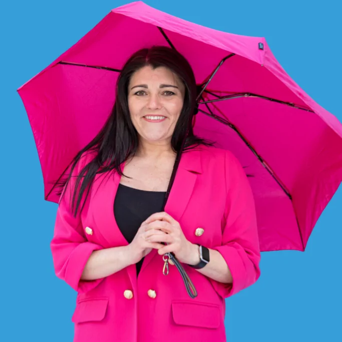 Tracy Heatley with a pink umbrella to show that I've got you covered when it comes to marketing and networking