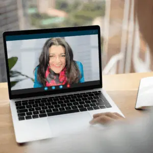 AI Marketing Consultancy Online Tracy Heatley, Chartered Marketer and AI Marketing Specialist, smiling during an online video call with a client, shown on a laptop screen.